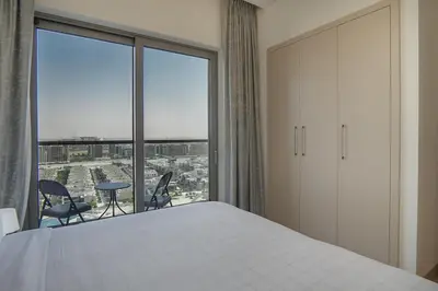 a bedroom with a bed and a large window at EasyGo-Modern, Distinguished with Sofa Bed in Dubai