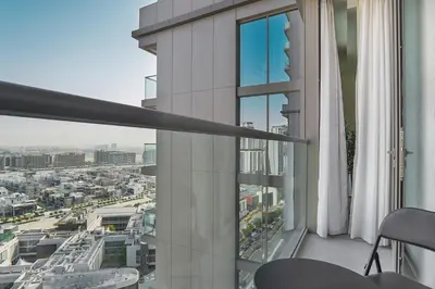 an apartment balcony with a view of a city at EasyGo-Modern, Distinguished with Sofa Bed in Dubai