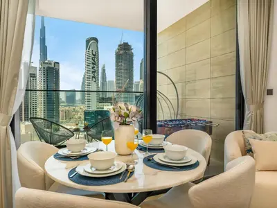 a dining room with a table with a view of the city at Exclusive 1BD with Burj View & Private Jacuzzi in Dubai