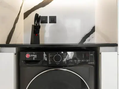 a black microwave oven with a black controller on top of it at Exclusive 1BD with Burj View & Private Jacuzzi in Dubai