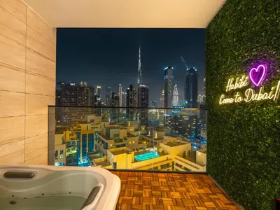 a bathroom with a view of a city skyline at Exclusive 1BD with Burj View & Private Jacuzzi in Dubai