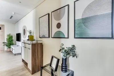 a living room with four pictures on the wall at GuestReady - Luxe waterfront stay in Dubai Marina in Dubai
