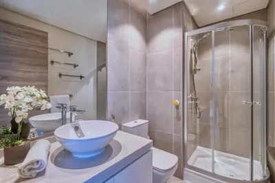a bathroom with a sink and a shower and a toilet at GuestReady - Luxe waterfront stay in Dubai Marina in Dubai