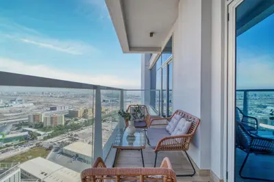 a balcony with chairs and tables and a view of the city at GuestReady - Luxe waterfront stay in Dubai Marina in Dubai