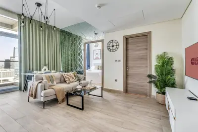 a living room with a couch and a table at GuestReady - Luxe waterfront stay in Dubai Marina in Dubai