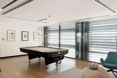 a billiard room with a pool table in it at Restay Homes - Fancy 2BR in Belgravia Heights - Pool access in Dubai