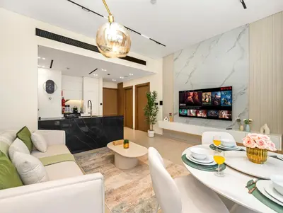 a living room with a white couch and a table at Chic 1BR Burj Khalifa Views Private Jacuzzi in Dubai