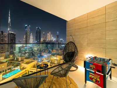 a room with a view of a city at night at Chic 1BR Burj Khalifa Views Private Jacuzzi in Dubai