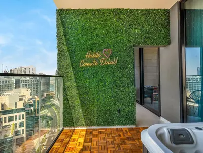 a green wall with a sign that reads love is queen at Chic 1BR Burj Khalifa Views Private Jacuzzi in Dubai