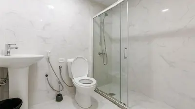 a bathroom with a shower and a toilet and a sink at The Manchester JBR Marina Apartment Private Room with shared washroom in Dubai