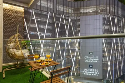 a table and chairs in a room with a window at Luxury 1 BR - Walk to Dubai Mall & Burj Khalifa in Dubai