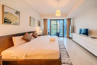 a bedroom with a large bed and a television at Trident Grand Residence 1 BDR plus Guest Bedroom, Dubai Marina in Dubai