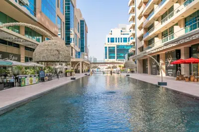 a pool in the middle of a city with buildings at Elegant Studio with Burj Khalifa Skyline Views in Dubai