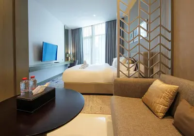 a hotel room with a couch and a bed at Sleek & Stylish Studio in DAMAC Prive, Dubai in Dubai