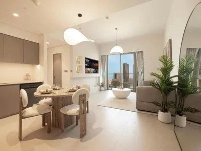 a kitchen and living room with a table and chairs at Grande Signature Residences by Prestige Nest in Dubai