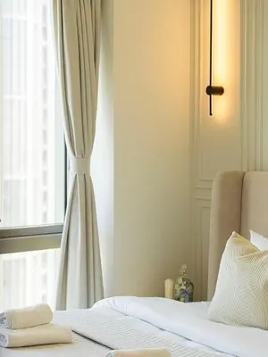 a bedroom with a bed and a window at Grande Signature Residences by Prestige Nest in Dubai