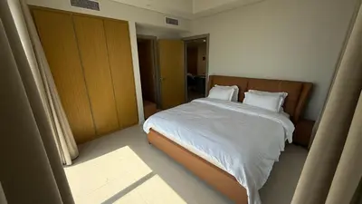 a bedroom with a bed with white sheets and pillows at Aykon city in Dubai