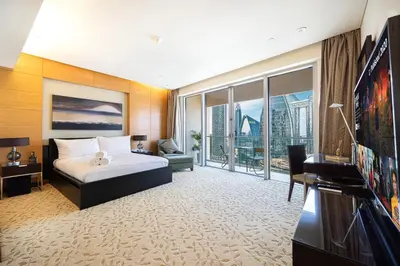 a hotel room with a bed and a large window at Burj Khalifa View & Mall Entry in 3 Mins & Sleeps 3 Adults in Dubai