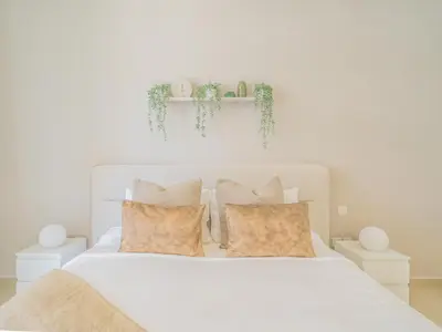 a bedroom with a white bed with two pillows at Chic Getaway with Balcony & Burj Khalifa View in Dubai