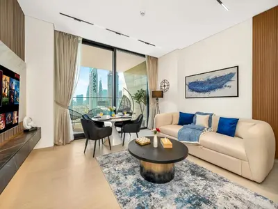 a living room with a couch and a table at Trendy 1BR Private Jacuzzi Burj Khalifa View in Dubai
