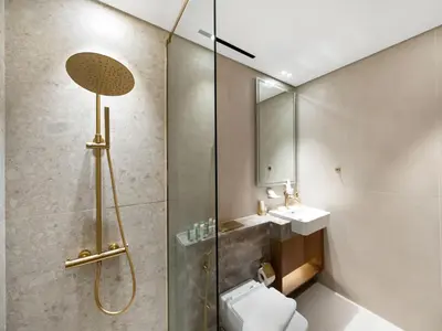 a bathroom with a shower and a toilet and a sink at Trendy 1BR Private Jacuzzi Burj Khalifa View in Dubai