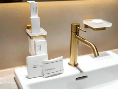 a sink with a gold faucet and boxes on it at Trendy 1BR Private Jacuzzi Burj Khalifa View in Dubai