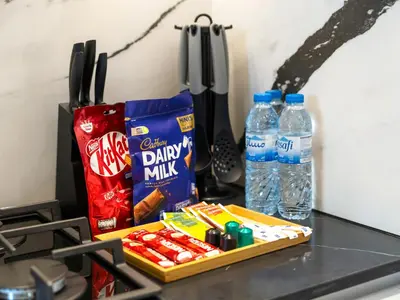 a counter top with a bag of chips and water bottles at Trendy 1BR Private Jacuzzi Burj Khalifa View in Dubai