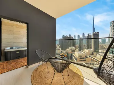 a dining room with a view of the city at Trendy 1BR Private Jacuzzi Burj Khalifa View in Dubai