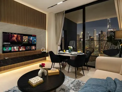 a living room with a tv and a table and chairs at Trendy 1BR Private Jacuzzi Burj Khalifa View in Dubai