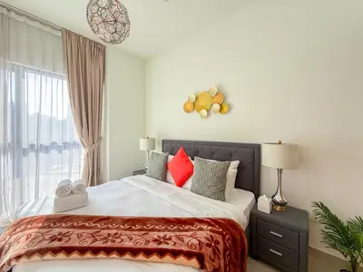 a bedroom with a large bed and a window at Burj Khalifa Panoramic view-1BR,4 guests, Downtown in Dubai