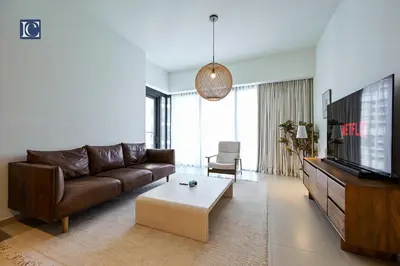 a living room with a couch and a tv at Stylish Downtown Dubai Stay Act 1 Act 2 Tower 1 in Dubai