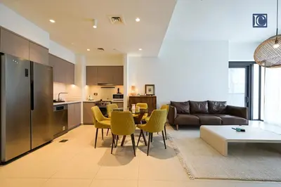 a living room with a couch and a table and chairs at Stylish Downtown Dubai Stay Act 1 Act 2 Tower 1 in Dubai