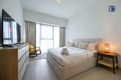 a bedroom with a bed and a flat screen tv at Stylish Downtown Dubai Stay Act 1 Act 2 Tower 1 in Dubai