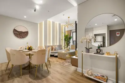 a dining room and living room with a table and chairs at Gogoto3 High Floor Burj Khalifa NYE Fireworks View PS5 in Dubai