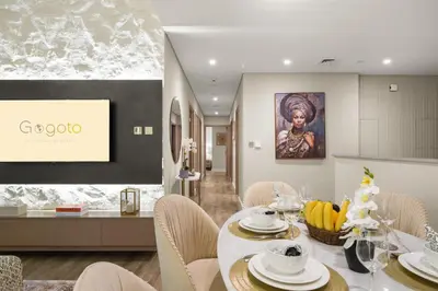 a dining room with a white table and chairs at Gogoto3 High Floor Burj Khalifa NYE Fireworks View PS5 in Dubai