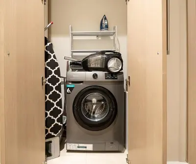 a washer and dryer in a room at Gogoto3 High Floor Burj Khalifa NYE Fireworks View PS5 in Dubai