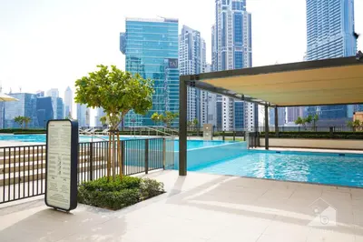 a swimming pool with a city skyline in the background at Burj Crown Luxurious 2Bedroom Balcony in Dubai