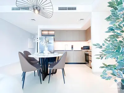 a dining room and kitchen with a table and chairs at Burj Crown Luxurious 2Bedroom Balcony in Dubai
