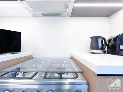 a stove top oven in a kitchen next to a counter at Burj Crown Luxurious 2Bedroom Balcony in Dubai