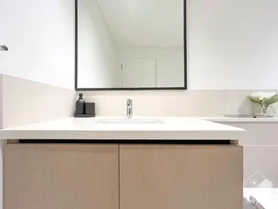 a bathroom with a white sink and a mirror at Burj Crown Luxurious 2Bedroom Balcony in Dubai