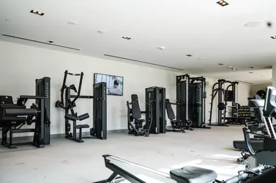 a gym with rows of exercise equipment in a room at Burj Crown Luxurious 2Bedroom Balcony in Dubai
