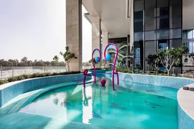 a swimming pool with a water slide in a building at Luxury 2BR Apartment Burj Khalifa View in Al Safa in Dubai