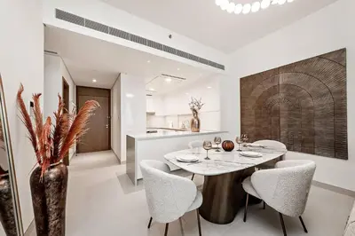 a kitchen and dining room with a table and chairs at Luxury 2BR Apartment Burj Khalifa View in Al Safa in Dubai
