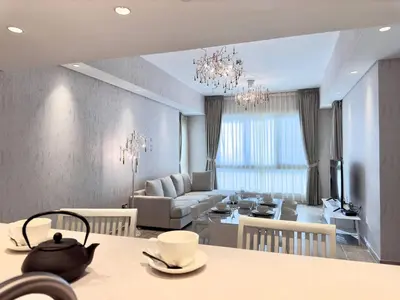 a living room with a table and a dining room at Luxury Spacious 2BR in Palm Jumeirah in Dubai