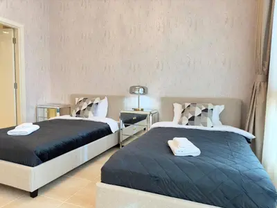 two beds sitting next to each other in a bedroom at Luxury Spacious 2BR in Palm Jumeirah in Dubai