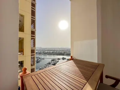 a room with a table and a view of a harbor at Luxury Spacious 2BR in Palm Jumeirah in Dubai