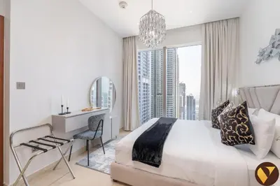 a bedroom with a bed and a desk and a window at Vogue Marina Gate near JBR Beach and Marina Mall, One Bedroom Apartment with Balcony and city skyline view, Access to all Amenities in Dubai