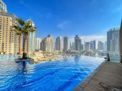 a swimming pool with a city skyline in the background at Vogue Marina Gate near JBR Beach and Marina Mall, One Bedroom Apartment with Balcony and city skyline view, Access to all Amenities in Dubai