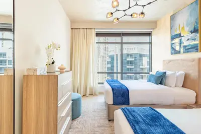 a hotel room with two beds and a window at Luxury Stay - Private Jacuzzi - Infinity Pool - Marina & Sea Views - High Floor - Upgraded - Designer - Squash in Dubai