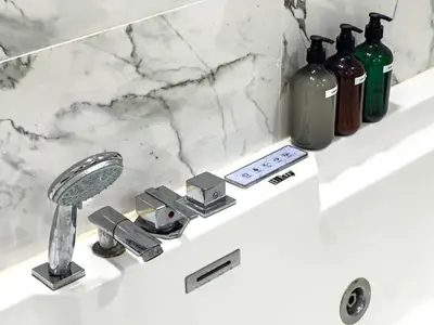 a bathroom sink with a faucet and some bottles at Luxury Stay - Private Jacuzzi - Infinity Pool - Marina & Sea Views - High Floor - Upgraded - Designer - Squash in Dubai
